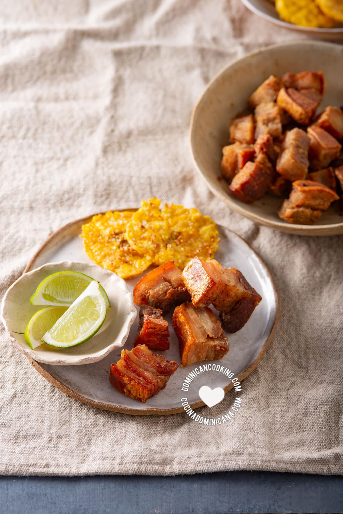 Air fryer chicharrones with tostones and lemon wedges.