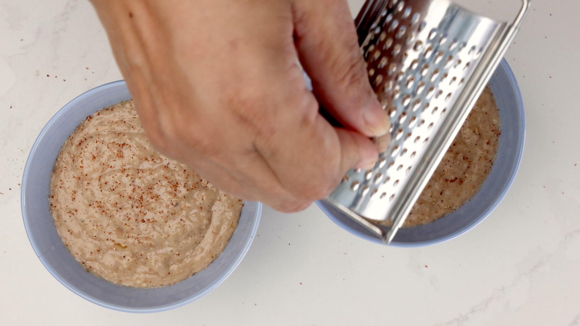 Sprinkling nutmeg.