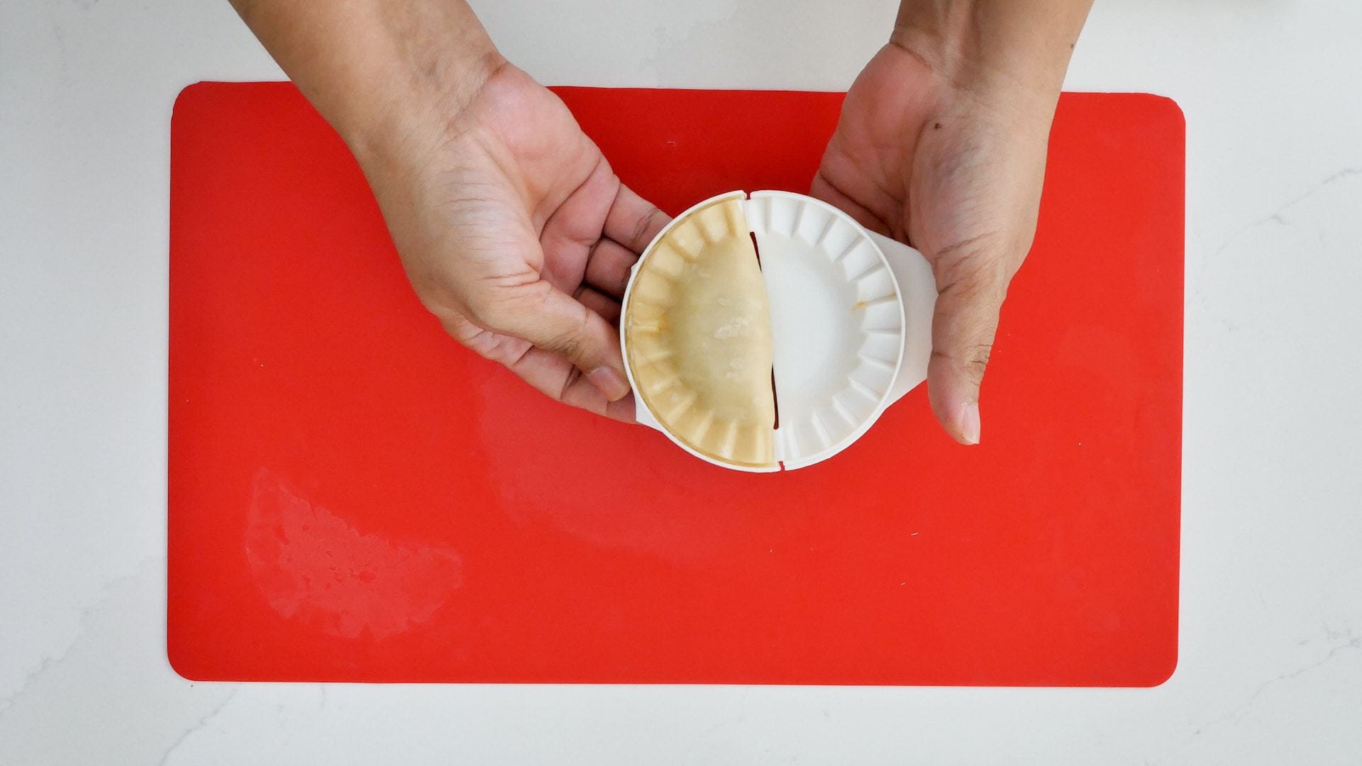 Forming empanadas.