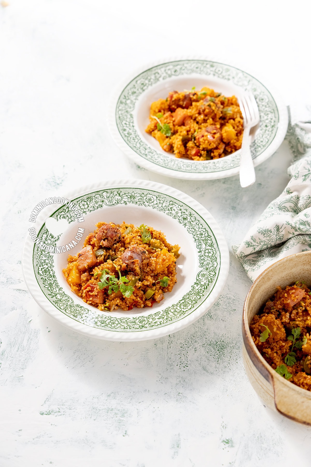 Plates of locrio de trigo (Dominican bulgur pilaf).