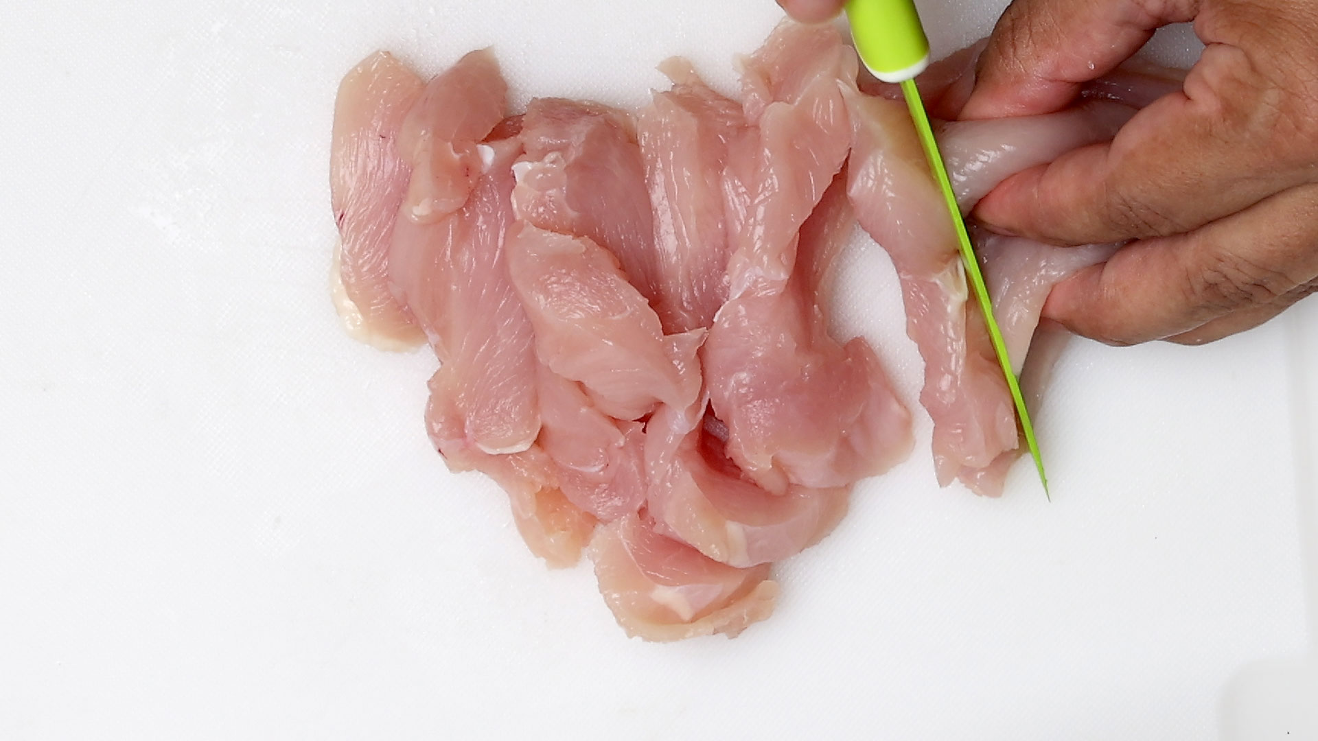 Cutting chicken.