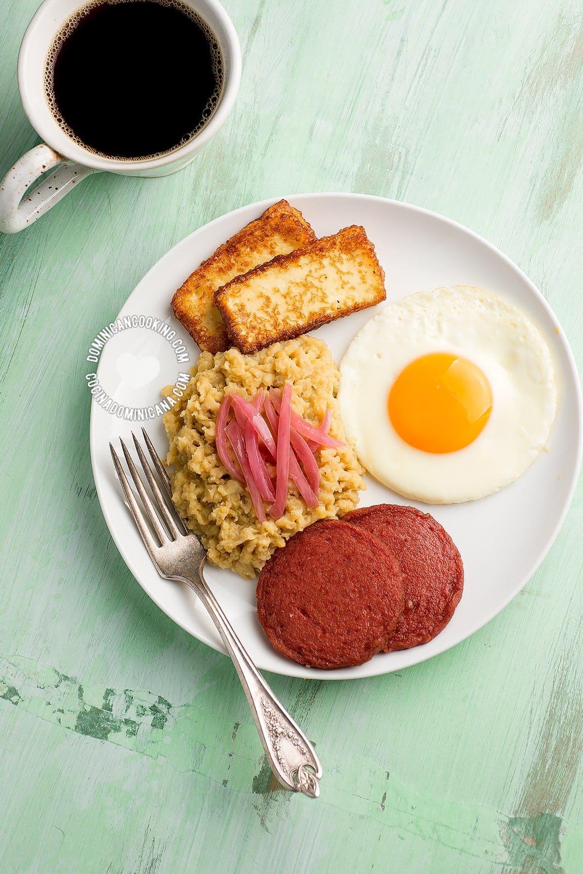 Dominican mangu for breakfast, served with salami frito, egg and fried cheese.