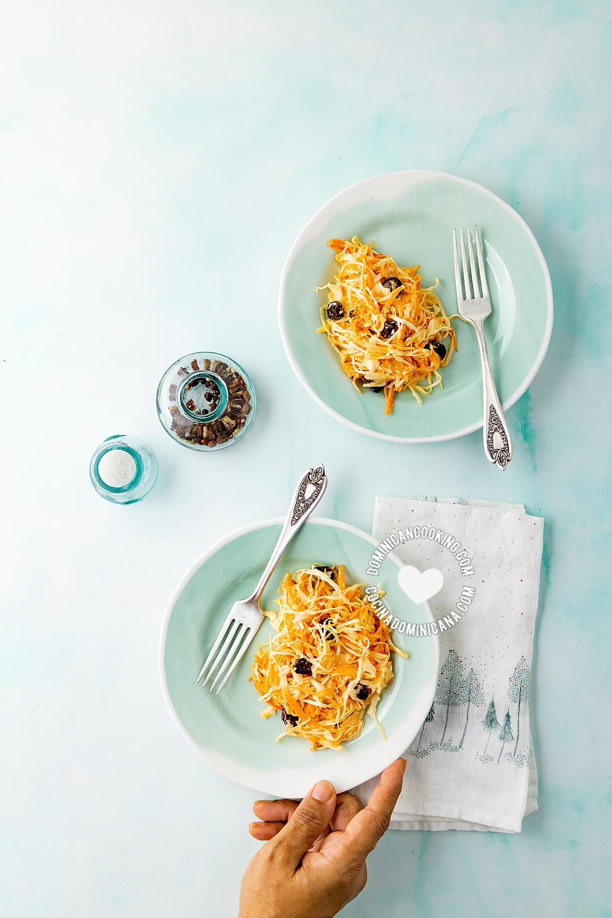 Two plates of cabbage and carrot salad.