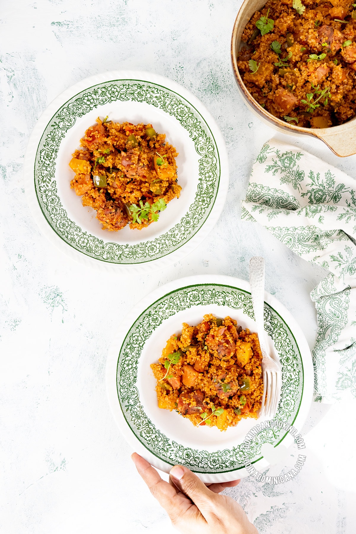 Two plates of locrio de trigo (Dominican bulgur pilaf).
