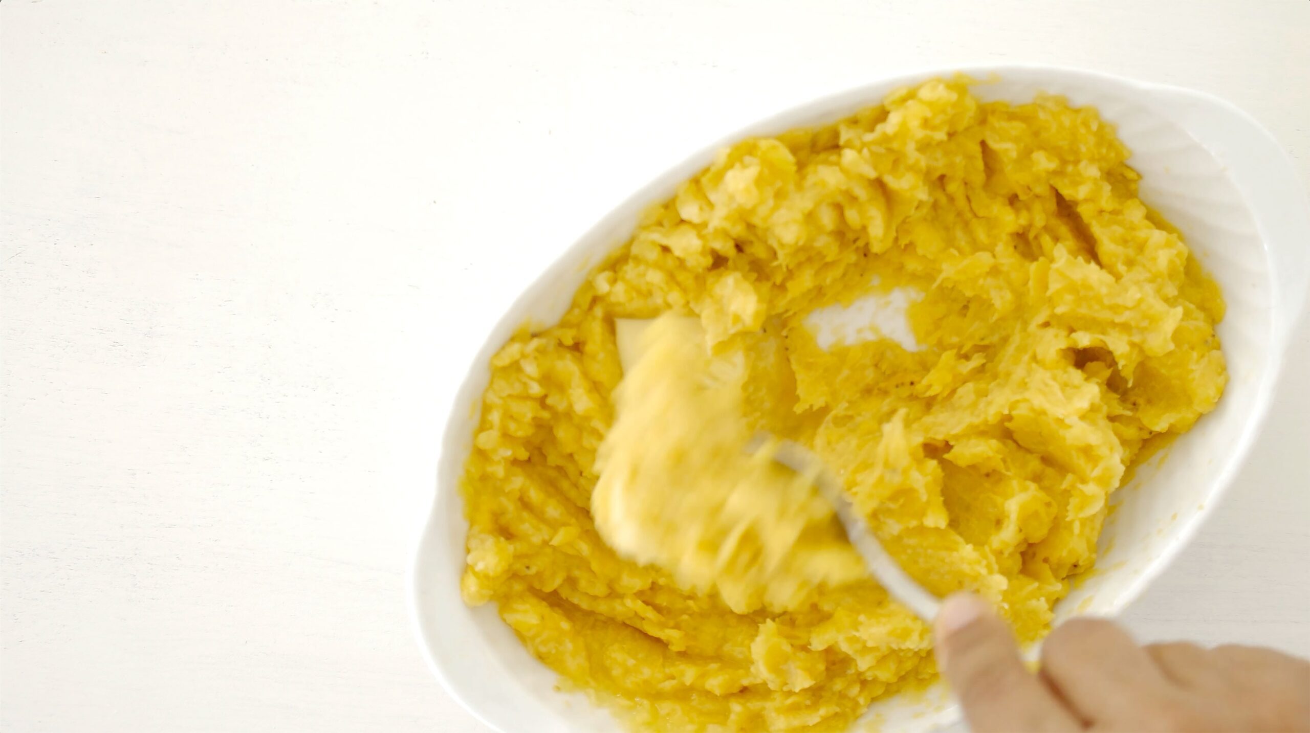 Mashing plantains.