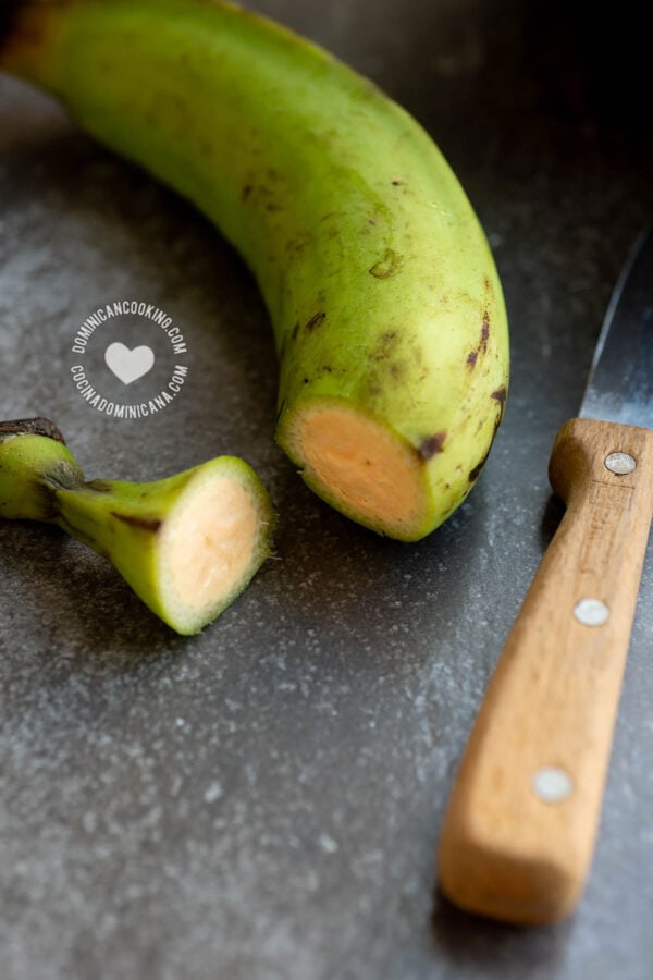 Peeling green unripe plantain.