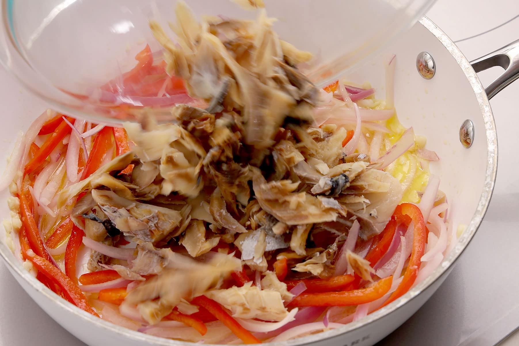 Adding bacalao.
